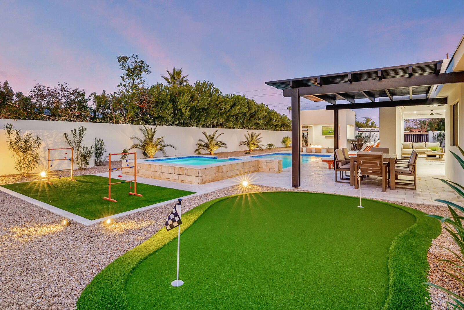 Querencia pool and putting green glowing at twilight, Scottsdale