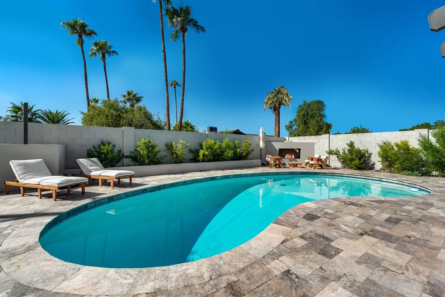 Vesper pool with its fireplace feature by day, Scottsdale